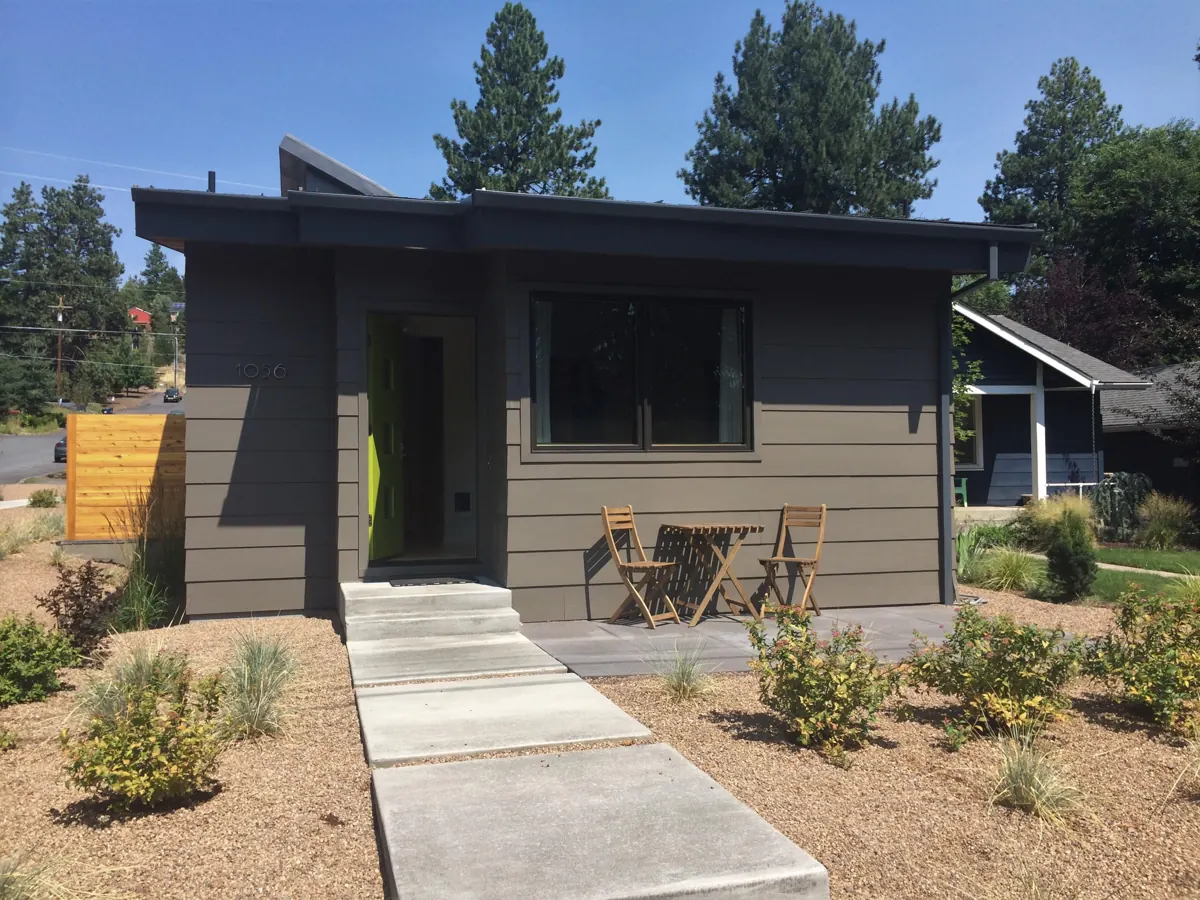 A modest detached accessory dwelling unit behind a primary home.