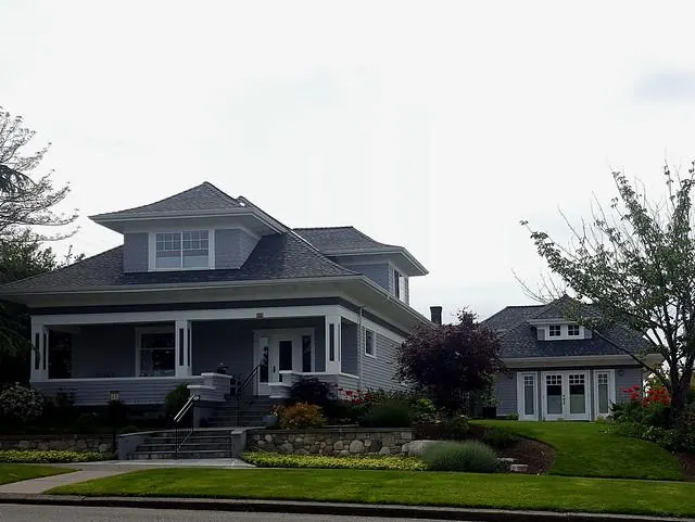 A craftsman home with a small backyard cottage or converted garage structure.